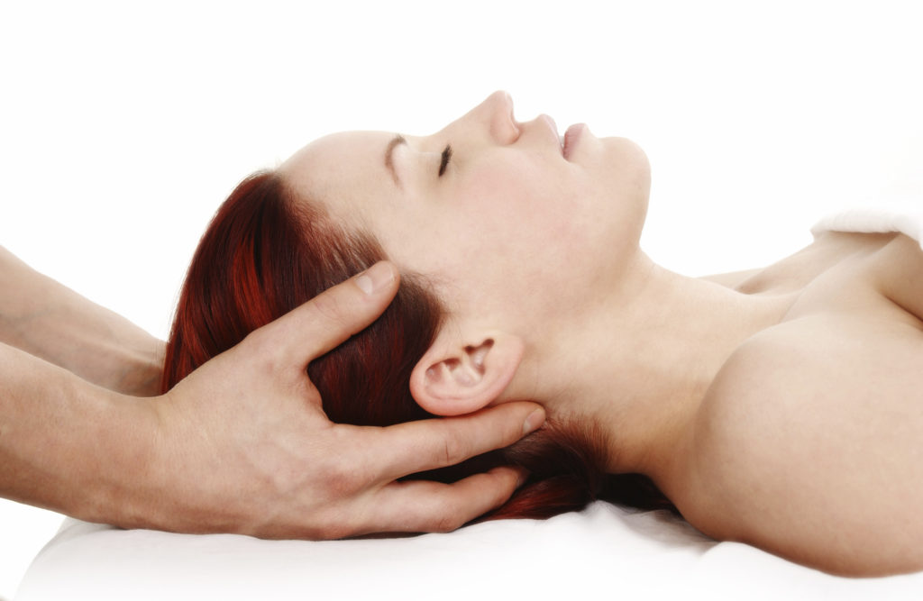 woman getting a head and shoulder massage on white background